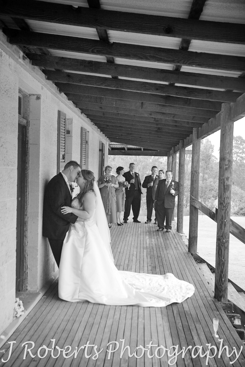 B&W of Bride and Groom with Bridal Party in background - wedding photography sydney